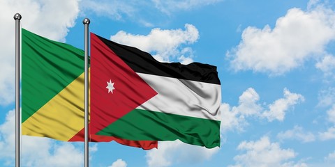 Republic Of The Congo and Jordan flag waving in the wind against white cloudy blue sky together....