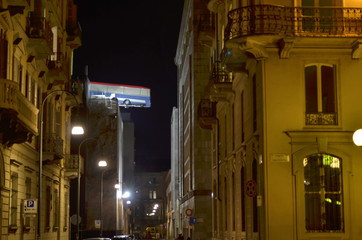 Turin, Piemonte, Italy. November 2019. A bus poised on the roof of a building. You can see the bus...