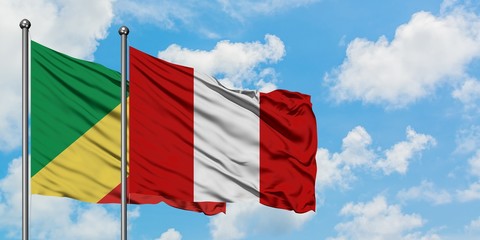 Republic Of The Congo and Peru flag waving in the wind against white cloudy blue sky together. Diplomacy concept, international relations.
