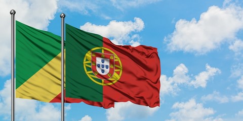 Republic Of The Congo and Portugal flag waving in the wind against white cloudy blue sky together. Diplomacy concept, international relations.