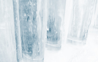 Thick pillars of blue ice recede into the background making an abstract pattern