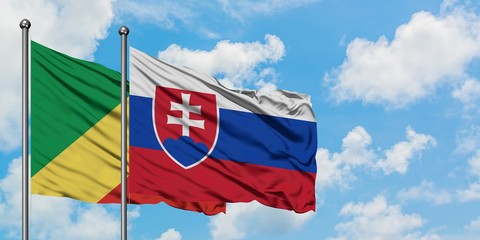Republic Of The Congo and Slovakia flag waving in the wind against white cloudy blue sky together. Diplomacy concept, international relations.