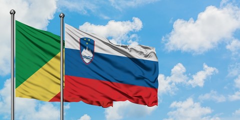 Republic Of The Congo and Slovenia flag waving in the wind against white cloudy blue sky together. Diplomacy concept, international relations.