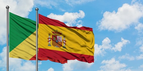 Republic Of The Congo and Spain flag waving in the wind against white cloudy blue sky together. Diplomacy concept, international relations.