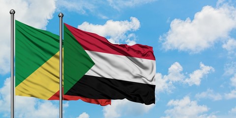 Republic Of The Congo and Sudan flag waving in the wind against white cloudy blue sky together. Diplomacy concept, international relations.