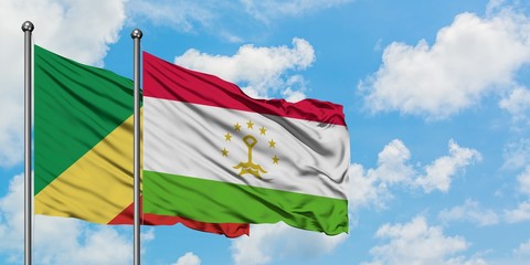 Republic Of The Congo and Tajikistan flag waving in the wind against white cloudy blue sky together. Diplomacy concept, international relations.
