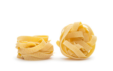 Pasta nest. Uncooked nest of tagliatelle pasta isolated on white background