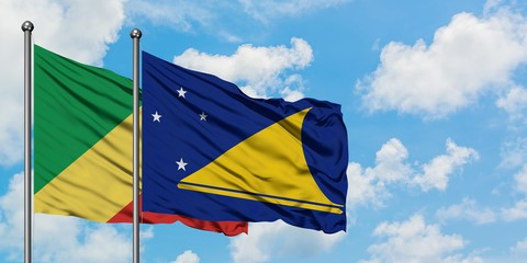 Republic Of The Congo and Tokelau flag waving in the wind against white cloudy blue sky together. Diplomacy concept, international relations.