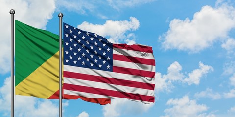 Republic Of The Congo and United States flag waving in the wind against white cloudy blue sky together. Diplomacy concept, international relations.