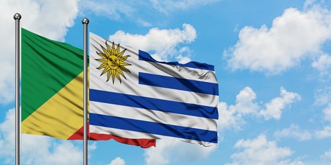 Republic Of The Congo and Uruguay flag waving in the wind against white cloudy blue sky together. Diplomacy concept, international relations.
