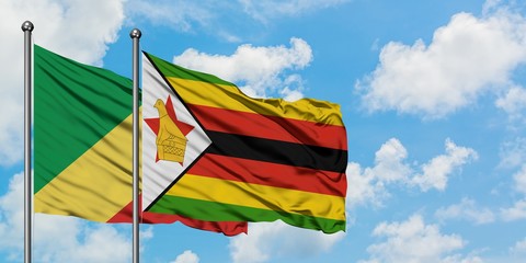 Republic Of The Congo and Zimbabwe flag waving in the wind against white cloudy blue sky together. Diplomacy concept, international relations.