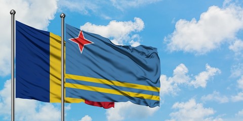 Romania and Aruba flag waving in the wind against white cloudy blue sky together. Diplomacy concept, international relations.