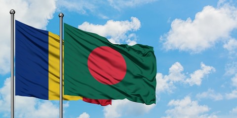 Romania and Bangladesh flag waving in the wind against white cloudy blue sky together. Diplomacy...
