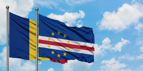 Romania and Cape Verde flag waving in the wind against white cloudy blue sky together. Diplomacy concept, international relations.