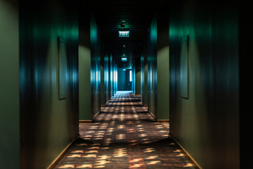 Dark corridor with light at the end inside a building