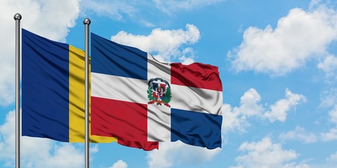Romania and Dominican Republic flag waving in the wind against white cloudy blue sky together. Diplomacy concept, international relations.