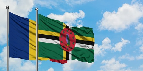 Romania and Dominica flag waving in the wind against white cloudy blue sky together. Diplomacy...