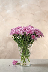 Beautiful chrysanthemum flowers in glass vase on table