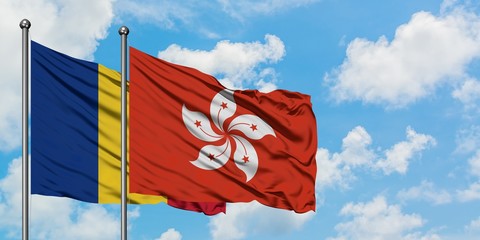 Romania and Hong Kong flag waving in the wind against white cloudy blue sky together. Diplomacy concept, international relations.