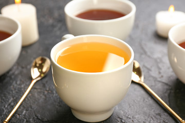 Cup of hot tea on dark background