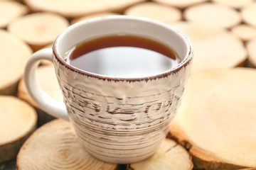 Cup of hot tea on wooden table