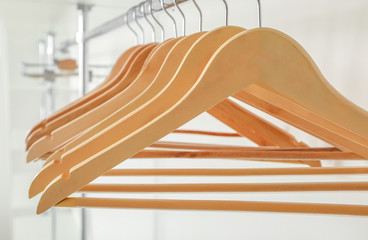 Obraz na płótnie Canvas Rack with clothes hangers on white background, closeup