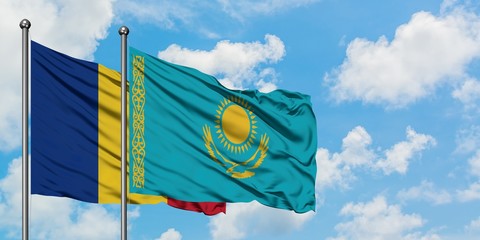 Romania and Kazakhstan flag waving in the wind against white cloudy blue sky together. Diplomacy...