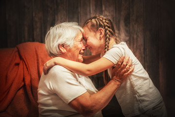grandmother plays with her granddaughter, depict a plane, hug, time with relatives - obrazy, fototapety, plakaty
