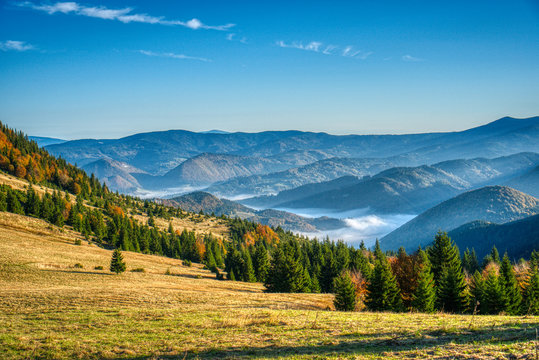 Fall colored valley with fog and mountains around , slovakia mala fatra