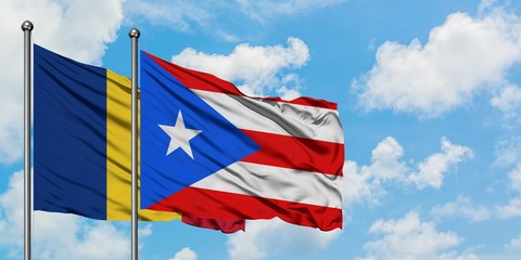 Romania and Puerto Rico flag waving in the wind against white cloudy blue sky together. Diplomacy concept, international relations.