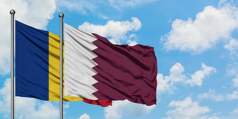 Romania and Qatar flag waving in the wind against white cloudy blue sky together. Diplomacy...