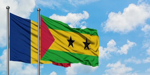Romania and Sao Tome And Principe flag waving in the wind against white cloudy blue sky together. Diplomacy concept, international relations.