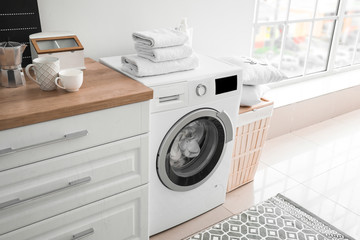 Interior of kitchen with modern washing machine
