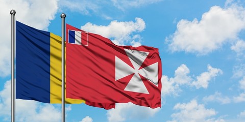 Romania and Wallis And Futuna flag waving in the wind against white cloudy blue sky together. Diplomacy concept, international relations.