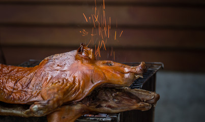 Roast pork on a charcoal flame.