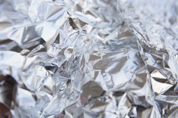 Aluminum foil abstract background. Crumpled silver foil background texture.