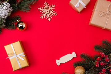 Top above high angle view photo of empty space surrounded with presents fir branches of snow and berries and snowflake isolated red vivid color background