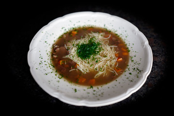 a hot soup with venison meat and vermicelli and carrot