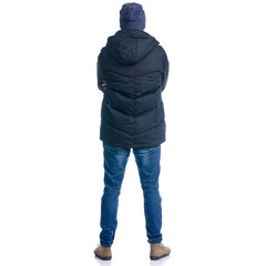 Man in winter jacket and warm hat standing looking