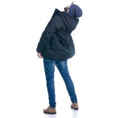 Man in winter jacket and warm hat standing looking up