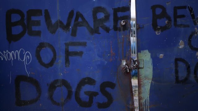 Beware of Dog warning, sign outside a scrap yard, home made signpost, stay out