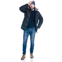 Fototapeta premium Man in winter jacket standing, thinking, hand on a head