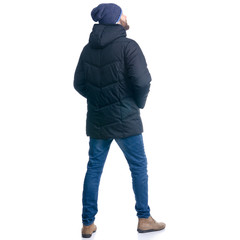 Man in winter jacket and warm hat standing looking