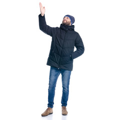 Man in winter jacket standing, looking, showing
