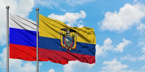 Russia and Ecuador flag waving in the wind against white cloudy blue sky together. Diplomacy concept, international relations.