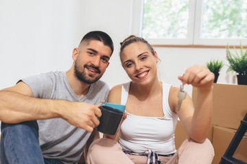 Fototapeta premium happy young family moving in their new home. holding home keys.