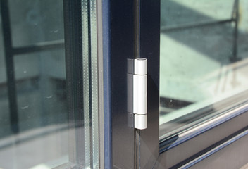 Close up on conservatory glass door door hinge