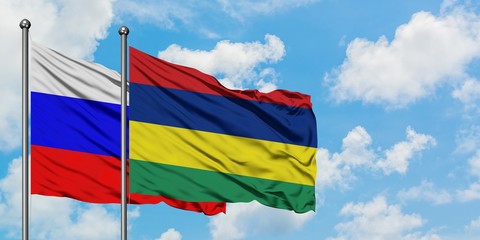 Russia and Mauritius flag waving in the wind against white cloudy blue sky together. Diplomacy concept, international relations.