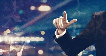 Businessma pointing something on night city background