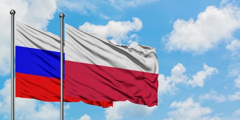 Russia and Poland flag waving in the wind against white cloudy blue sky together. Diplomacy concept, international relations.